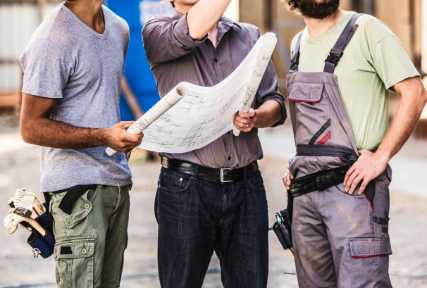 Construction worker reviewing blueprints